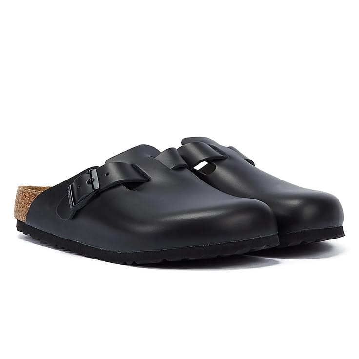 Pair of black clogs with cork sole on a white background