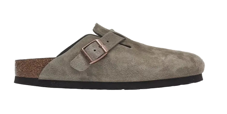 Brown suede clog shoe with a buckle on a white background